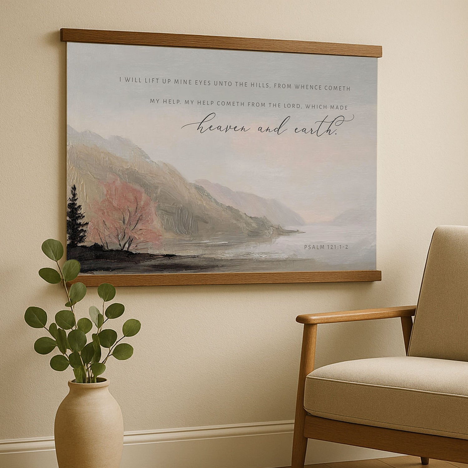 a large painting of a serene landscape with mountains, trees, and a body of water, hanging on a wall above a wooden chair.