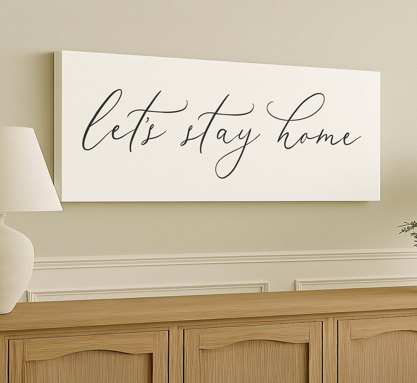 a white sign that says let't stay home on a wall