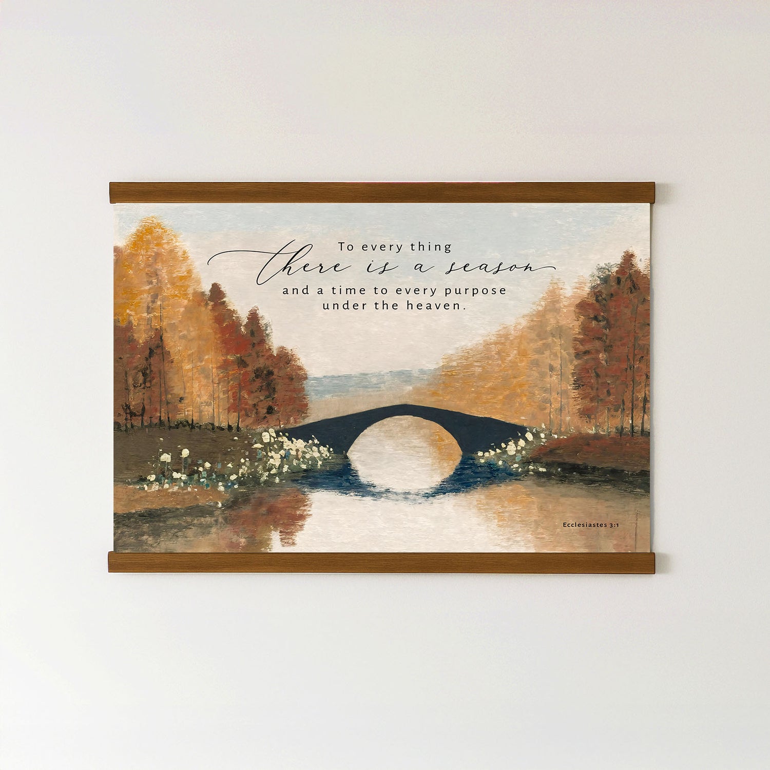 The image is a framed painting depicting a serene landscape with a bridge over a river, surrounded by trees with autumn foliage. The painting is mounted on a wall, and there is a quote in the top right corner that reads, "To every thing there is a season, and a time to every purpose under the heavens."
