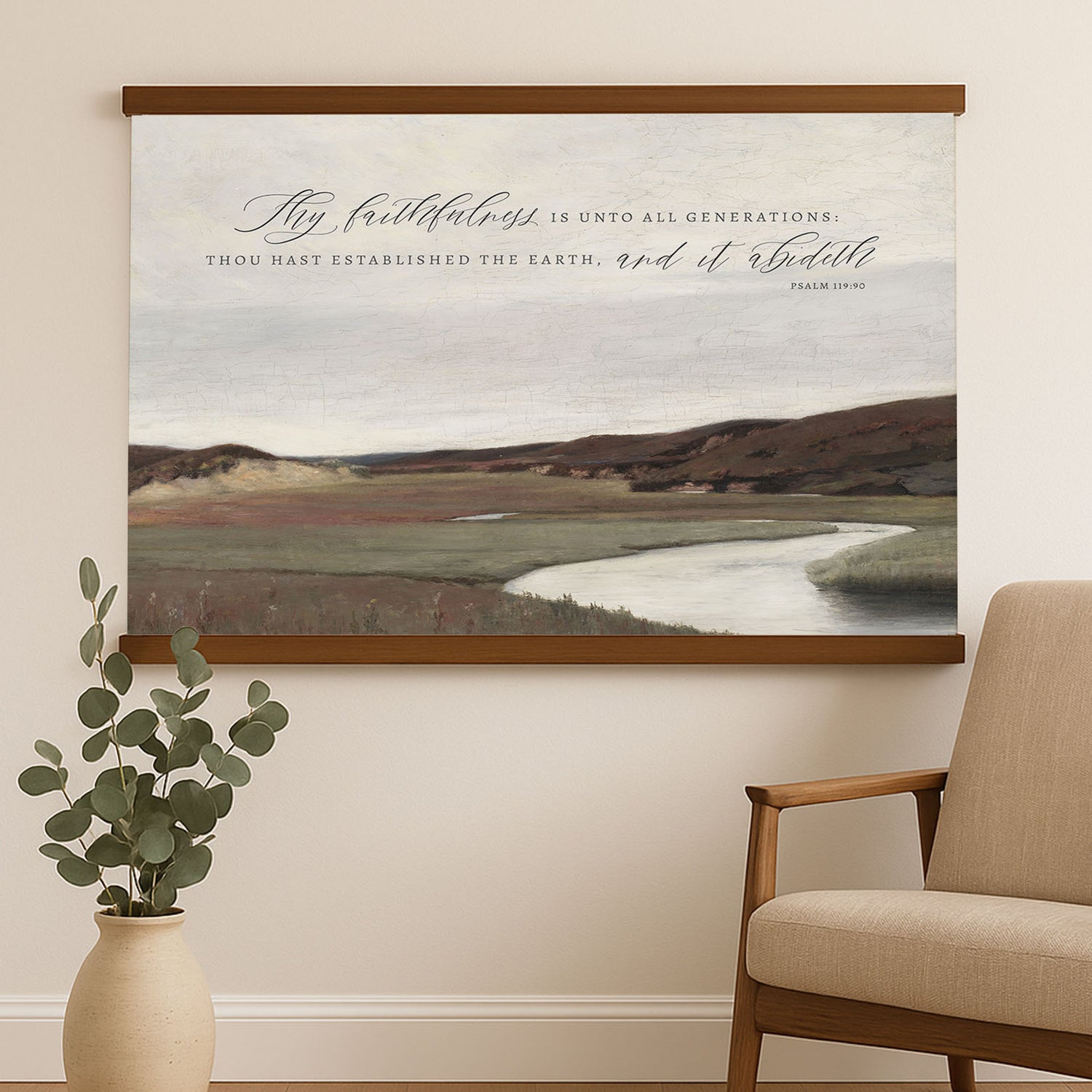 a large landscape painting hanging on a wall, with a wooden chair and a potted plant in the foreground.