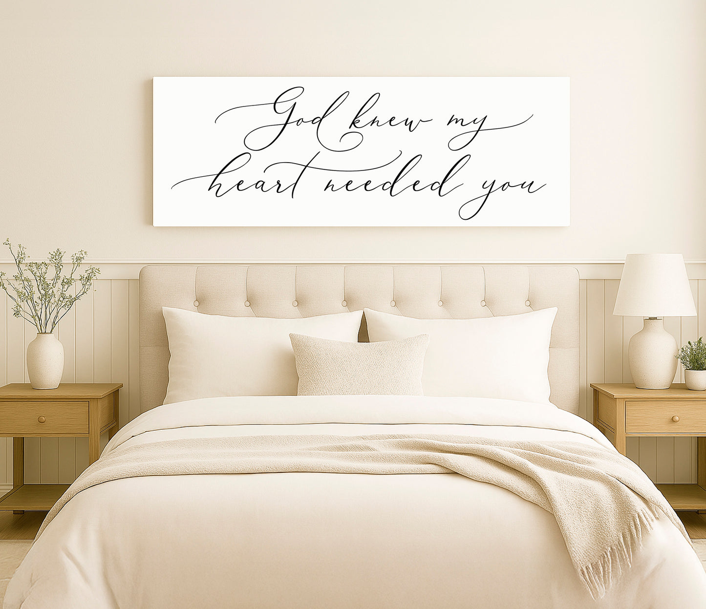 a bed with a white comforter and pillows