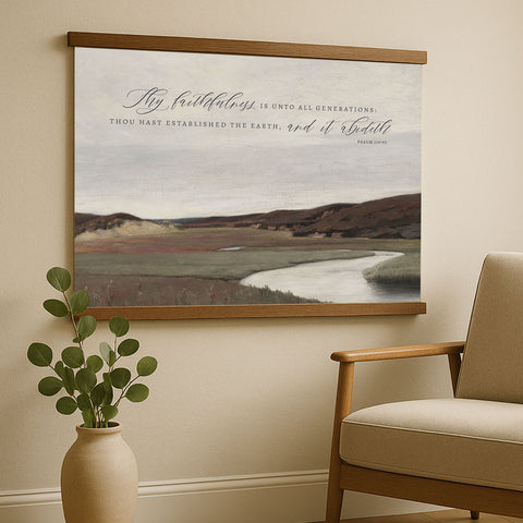 a painting of a serene landscape with a river and mountains in the background, hanging on a wall above a wooden chair.