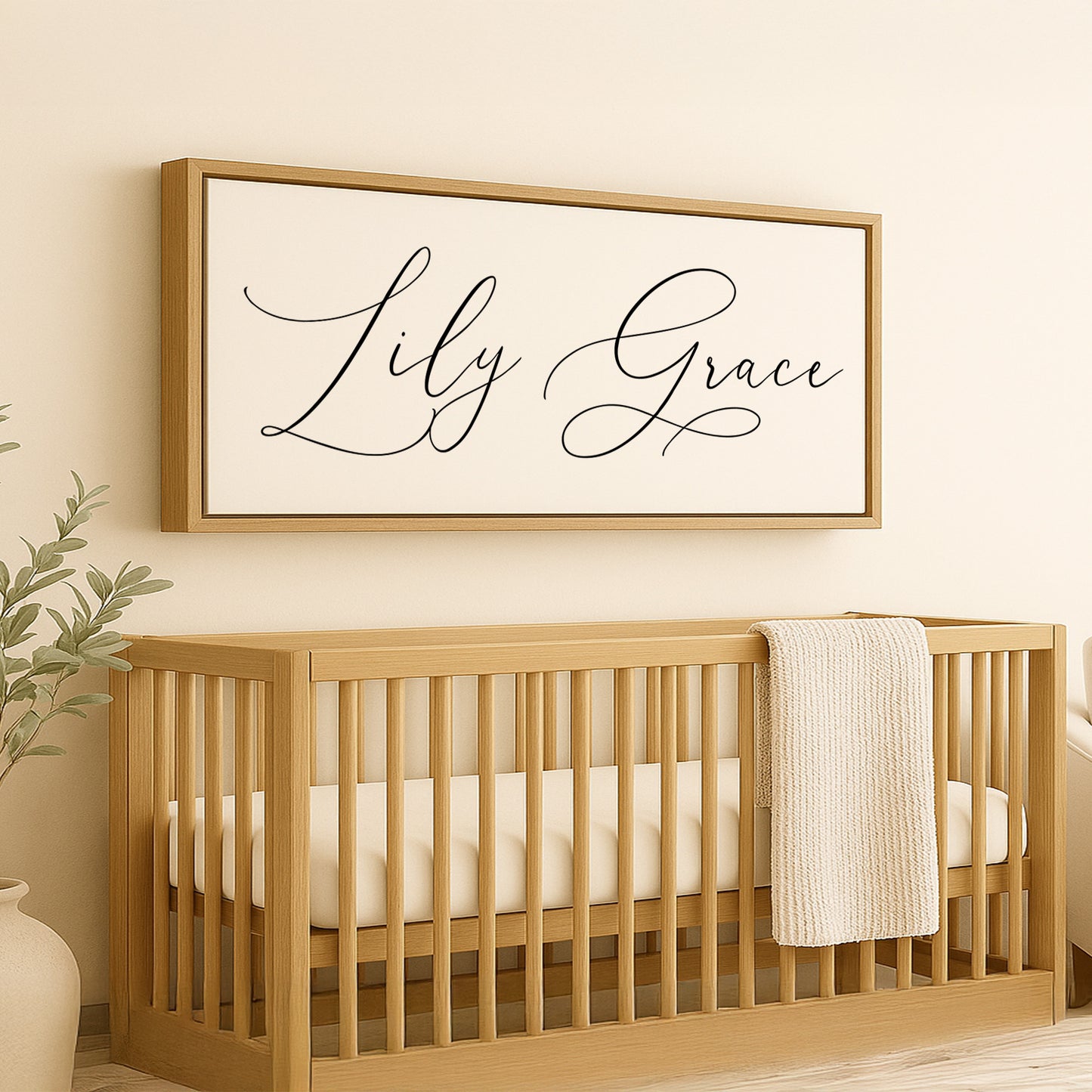 a baby crib with a white blanket and a wooden framed sign above it
