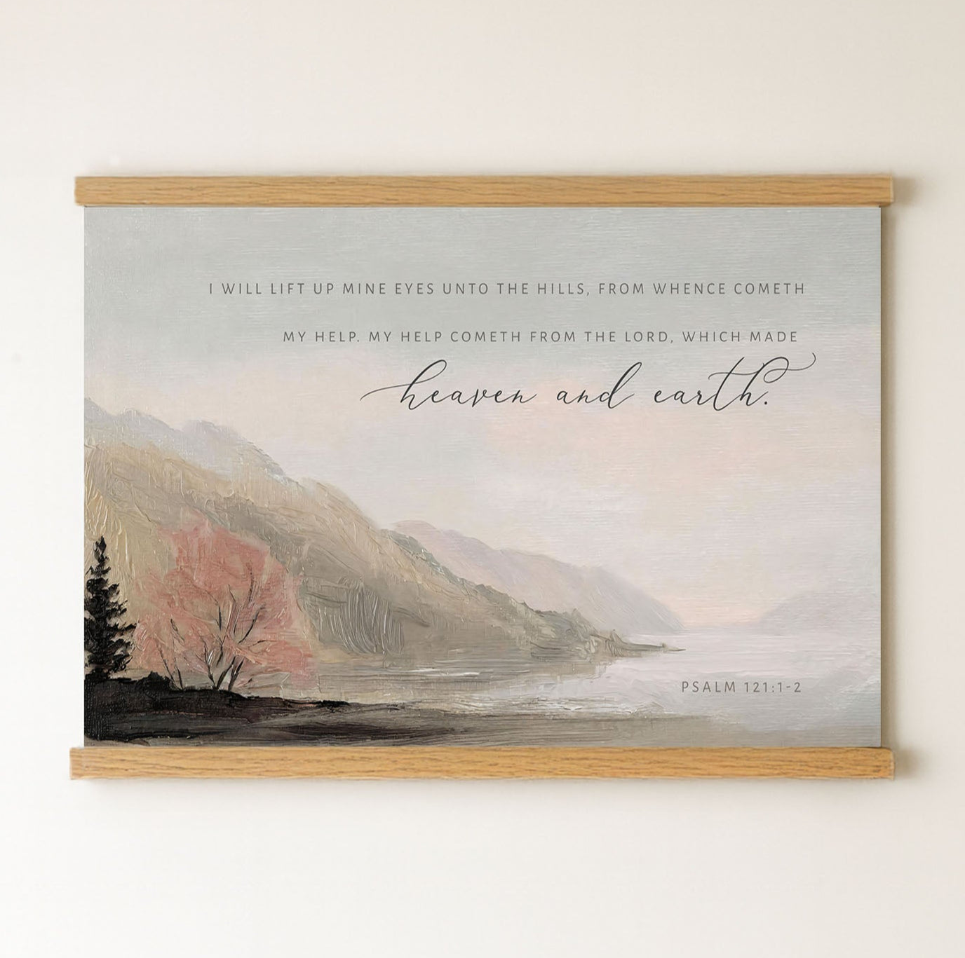 The image is a framed painting depicting a serene landscape with mountains, trees, and a body of water. The painting is mounted on a wall and features a Bible verse from Psalm 121:1-2.