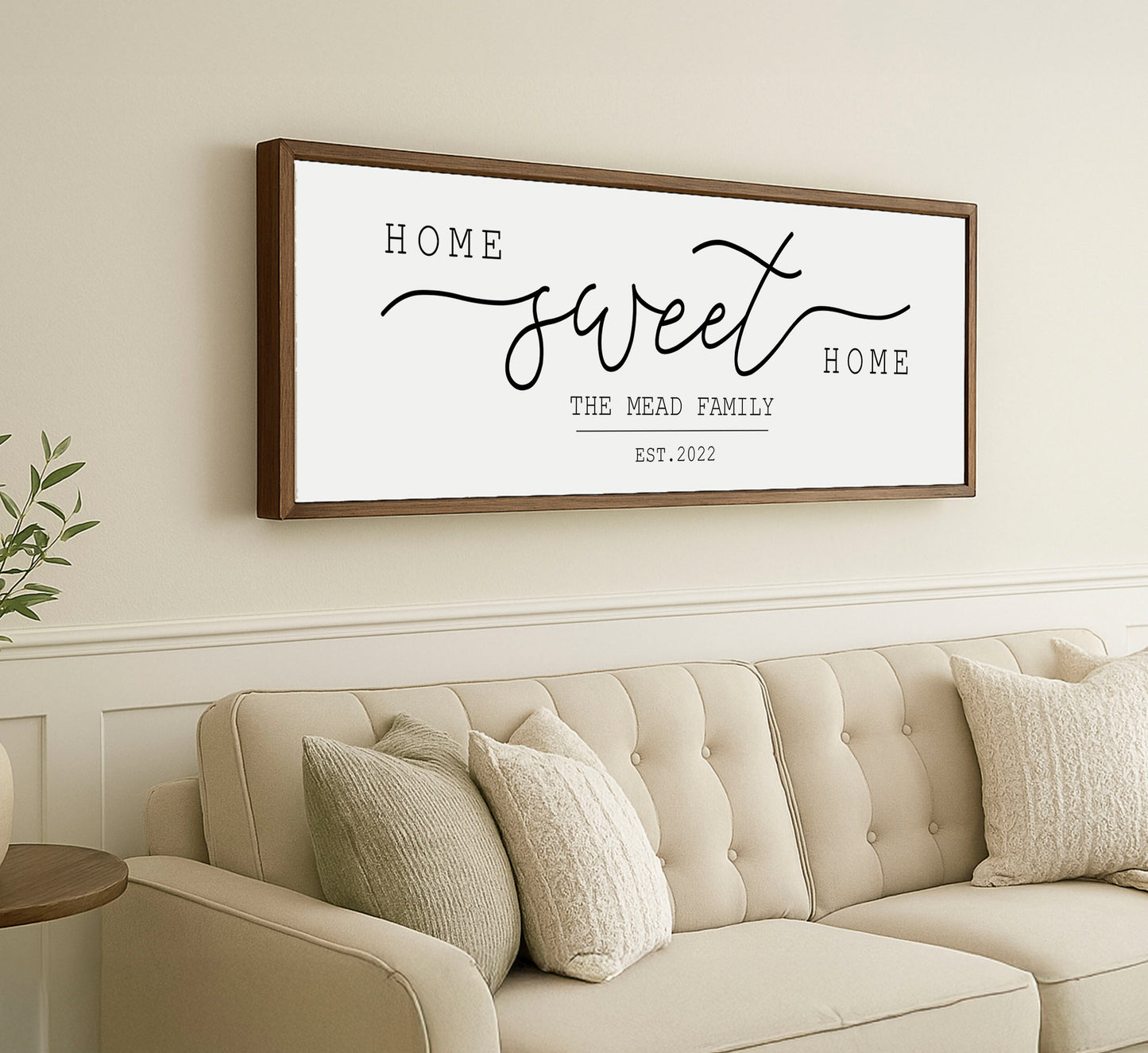 a living room with a couch and a framed sign on the wall