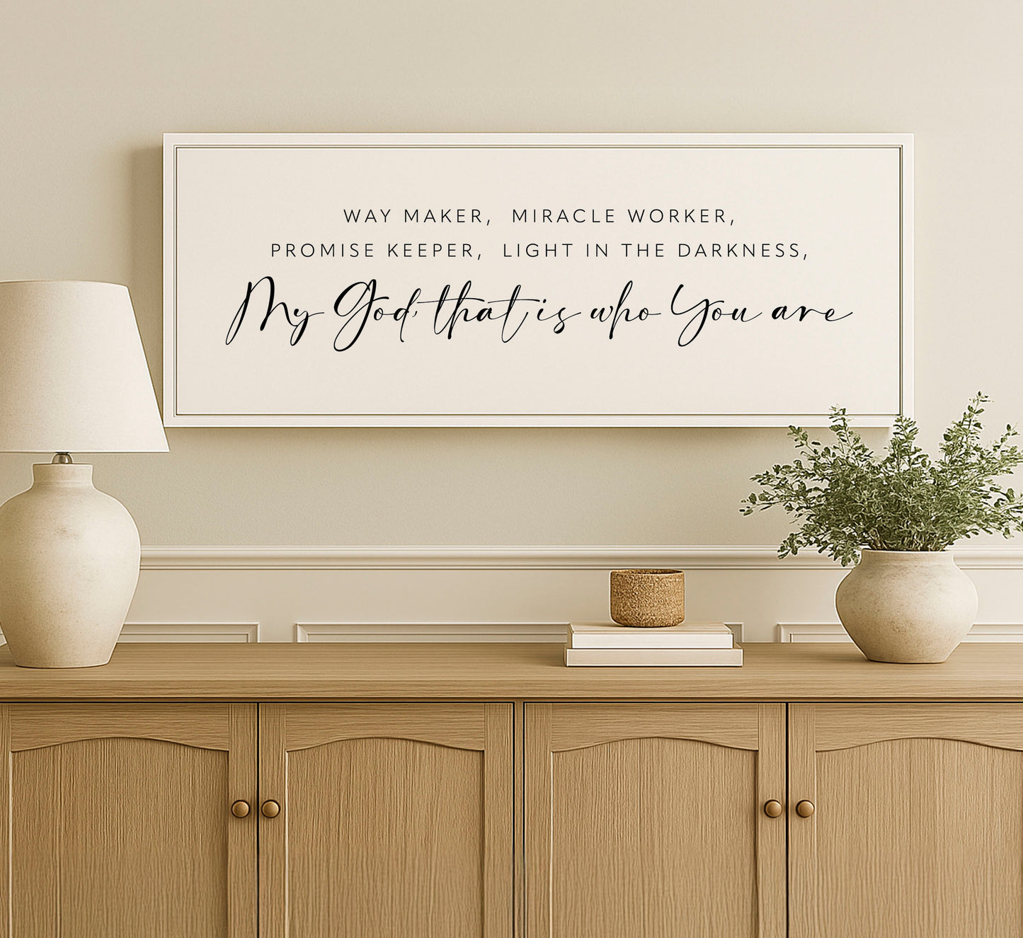 a picture of a vase and a lamp on a dresser