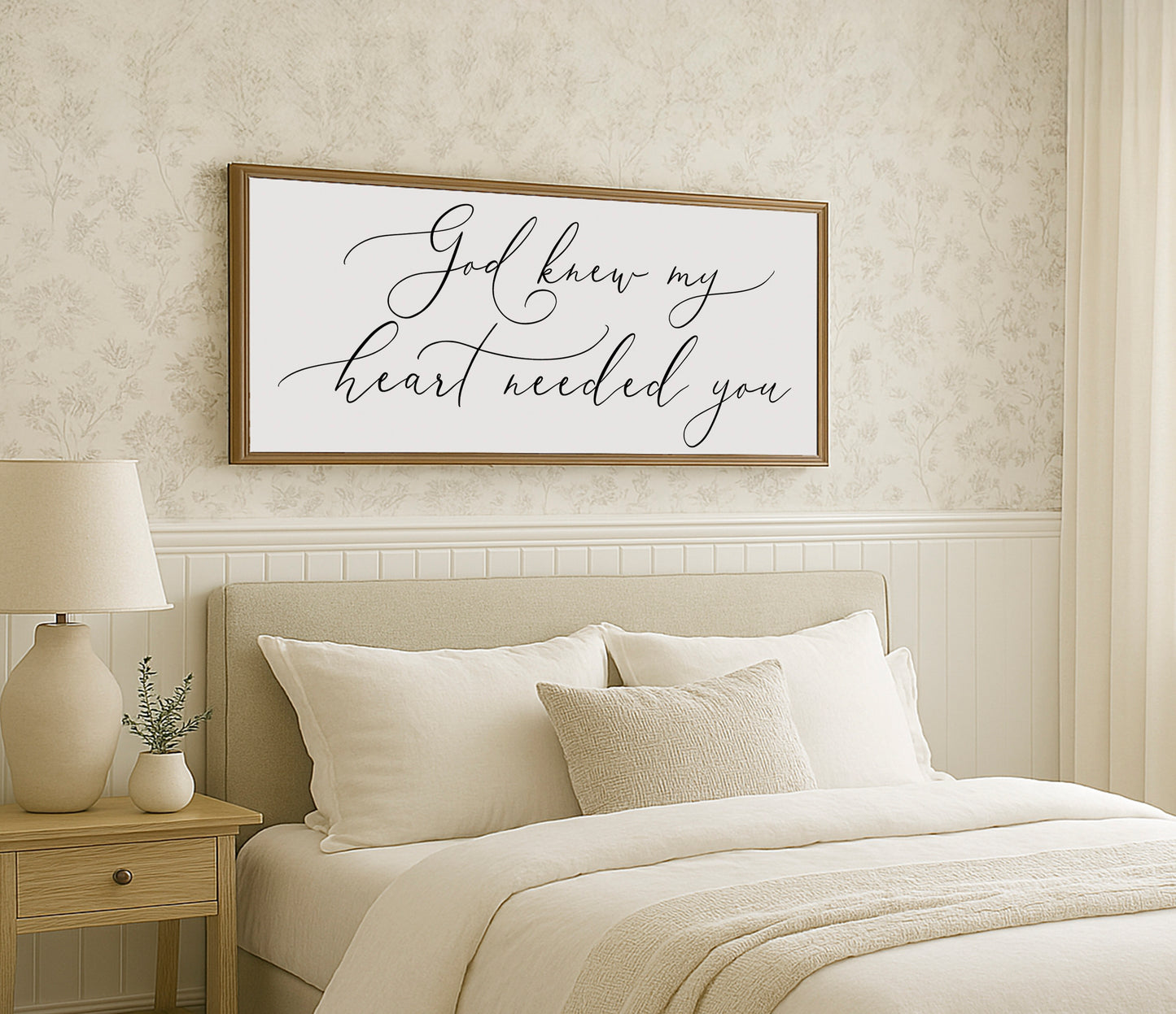 a bedroom with a white bed and a framed picture