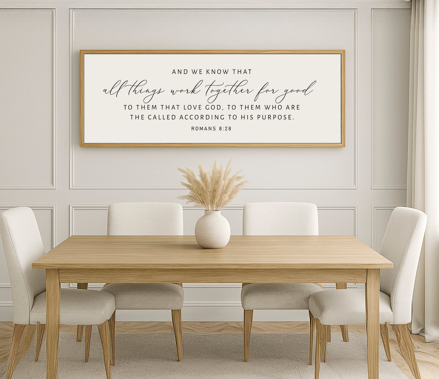 a dining room table with white chairs and a framed quote on the wall