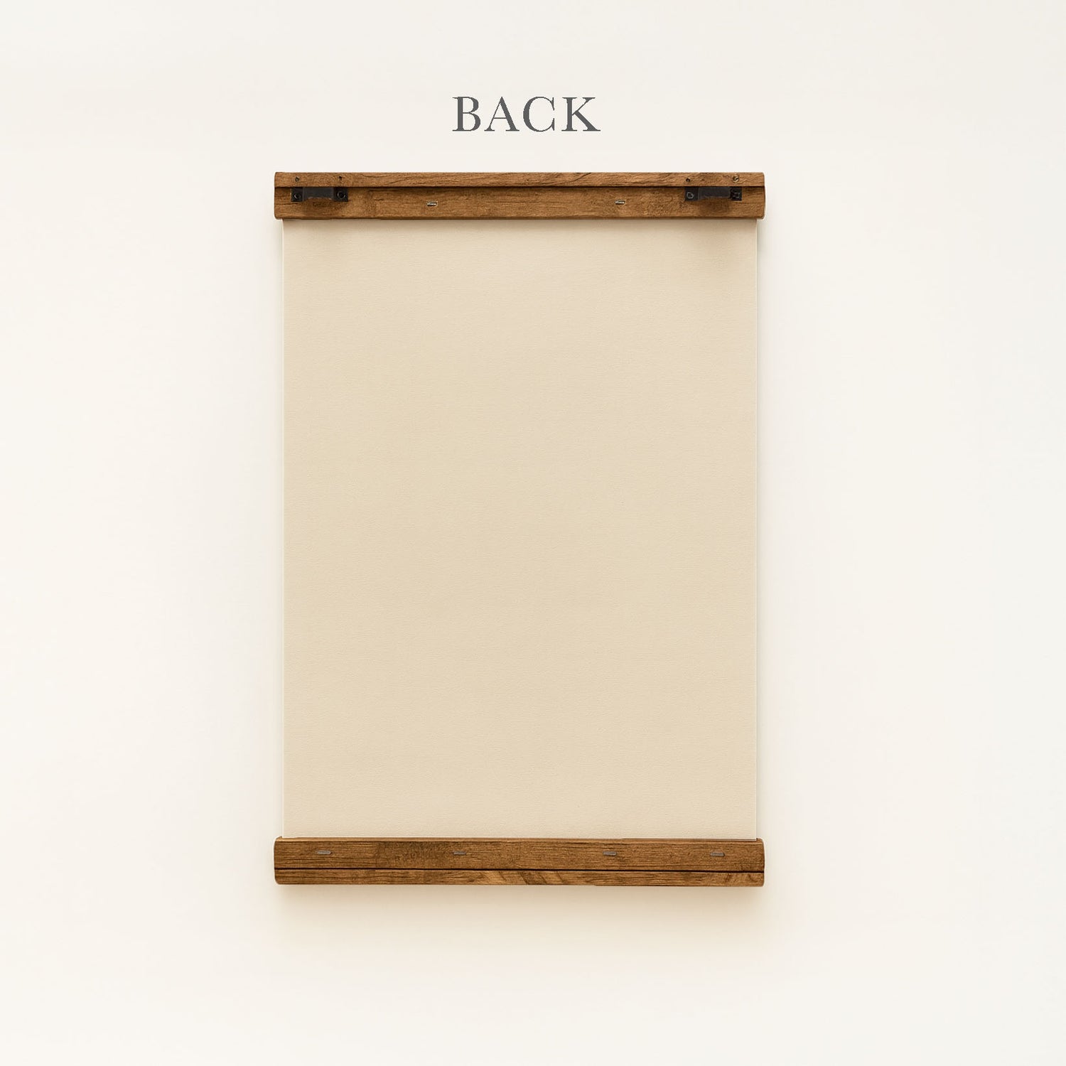 a wooden frame with a blank canvas or paper inside, mounted on a white wall.