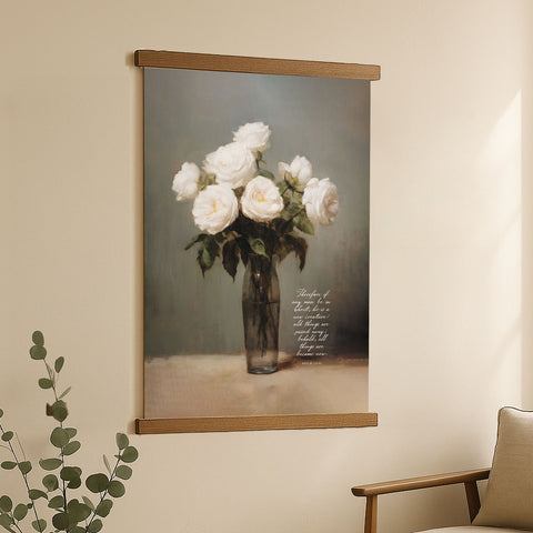 The image is a framed painting of a vase filled with white roses, hanging on a wall in a living room.