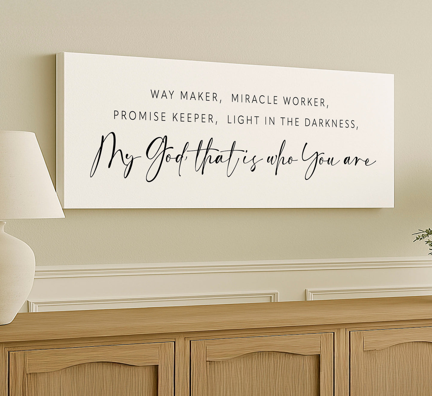 a white sign on a wall above a dresser
