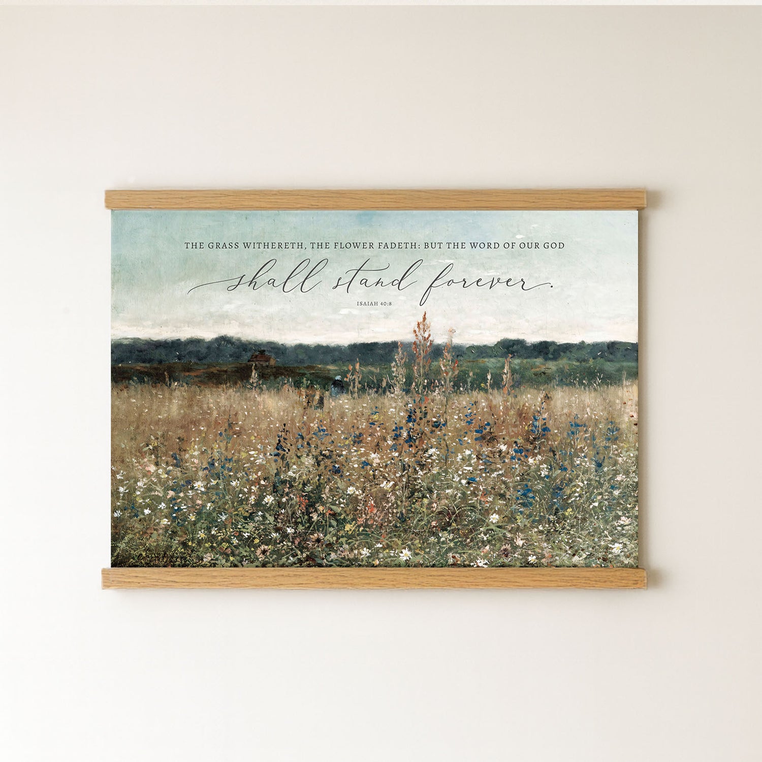 The image is a framed print of a pastoral landscape with a quote from the Bible, "The grass withers, the flower fades, but the word of our God shall stand forever."