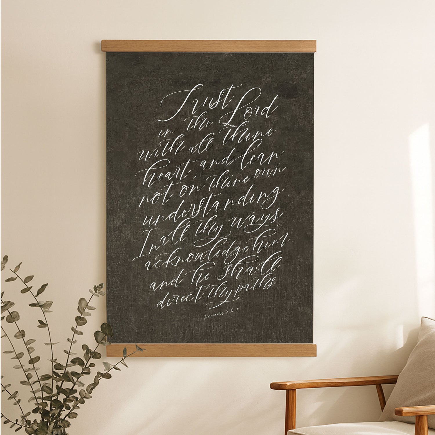 a blackboard with white handwritten text, hanging on a wall next to a wooden chair.