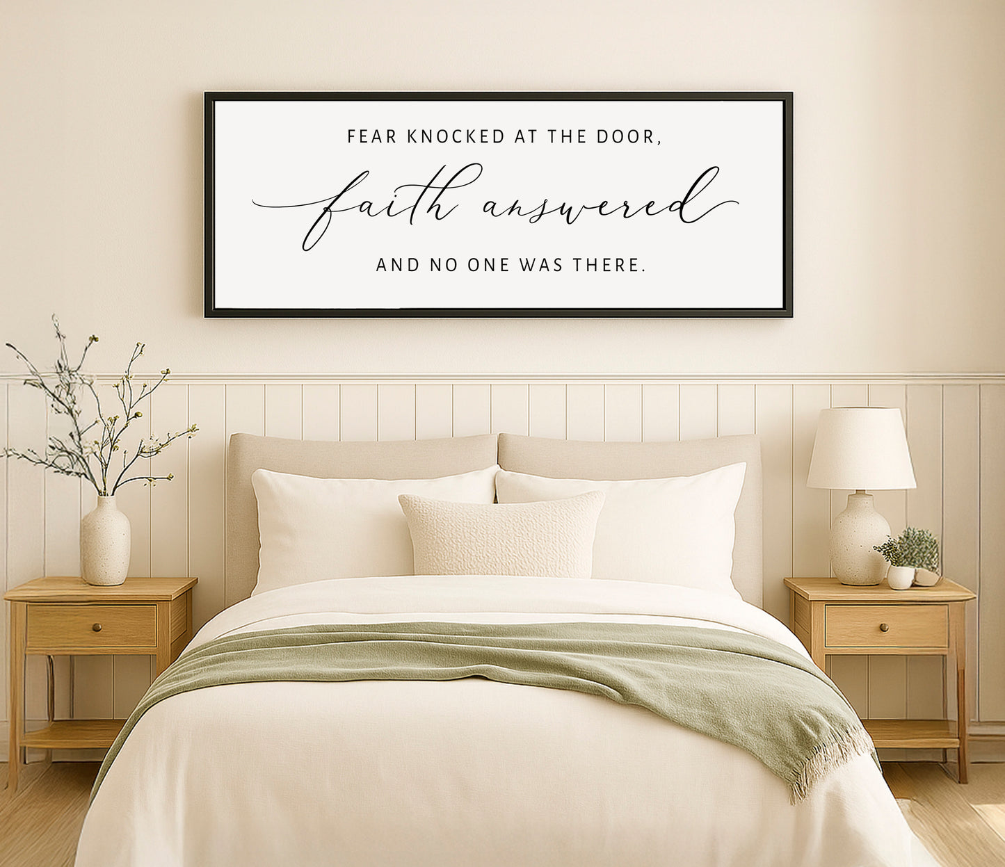 a bedroom with a bed, nightstands and a framed poster