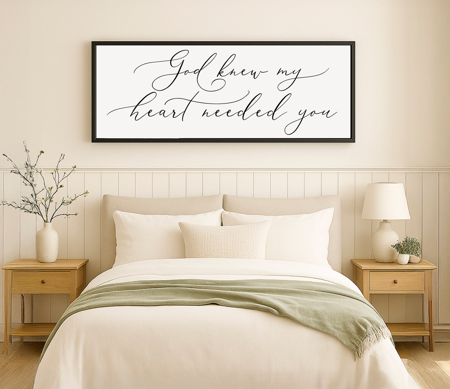 a bedroom with a bed, nightstands and a framed picture