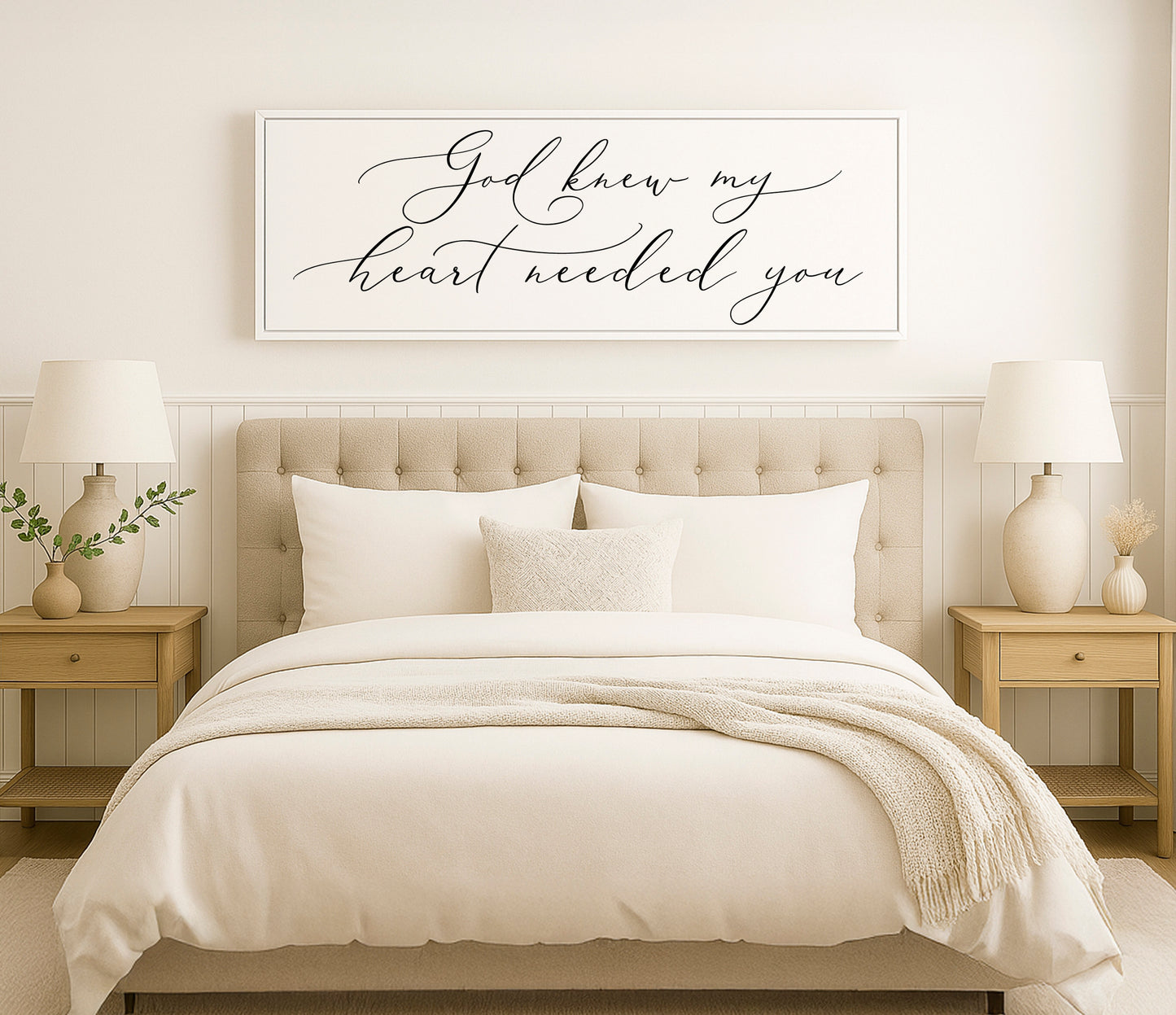 a bed with a white comforter and pillows