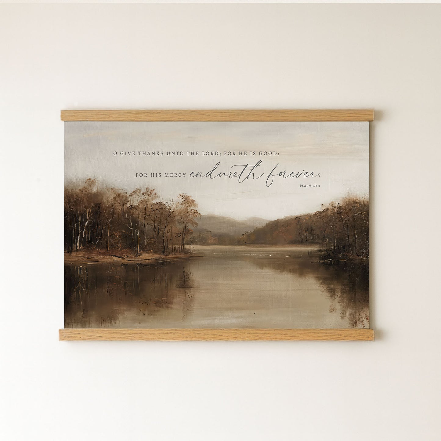 The image is a framed print of a serene landscape featuring a calm lake surrounded by trees and mountains. The text on the print reads, "O GIVE THANKS UNTIL THE LORD IS GOOD. FOR HIS MERCY ENDLESS FOREVER."