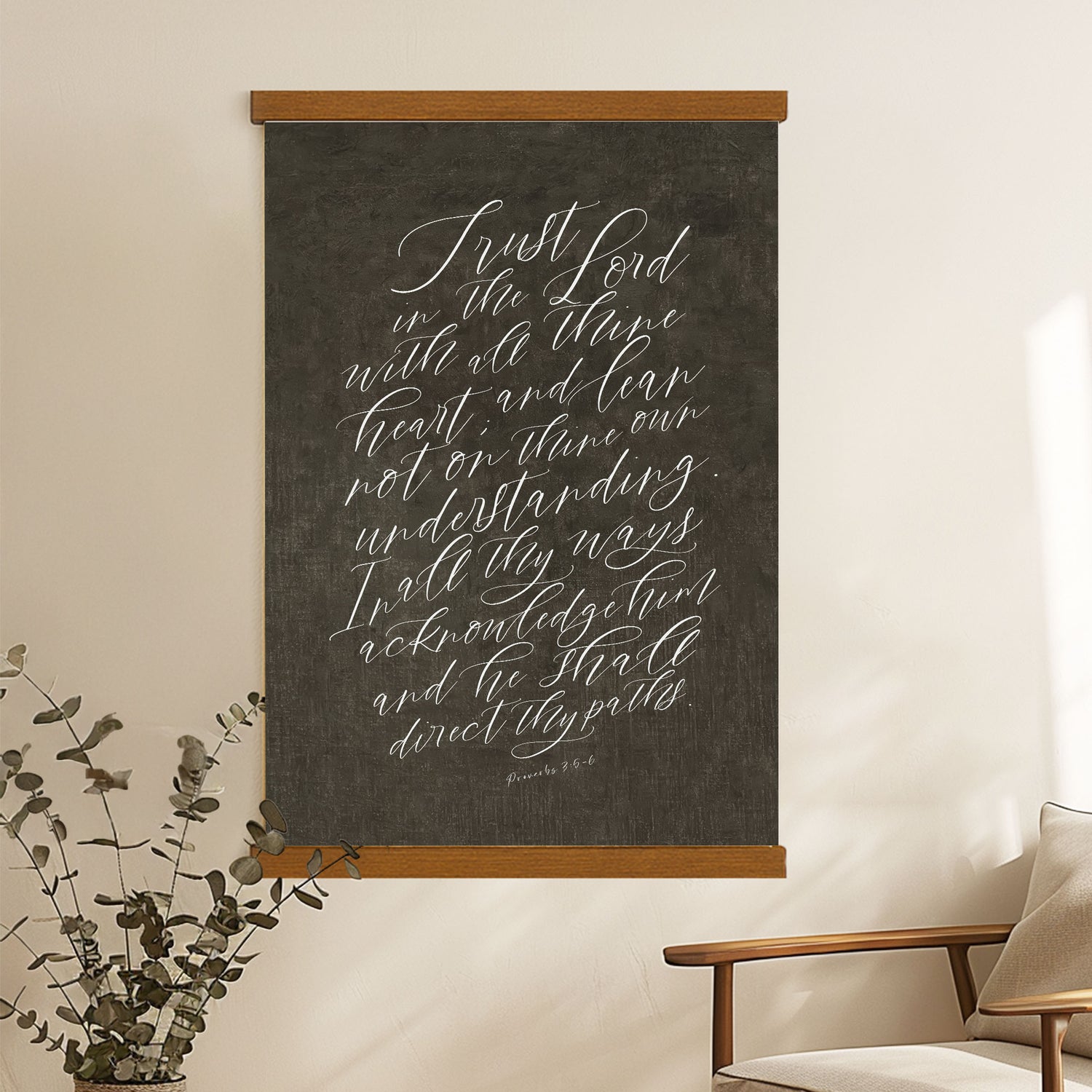 a blackboard with white handwritten text, hanging on a wall next to a wooden chair.