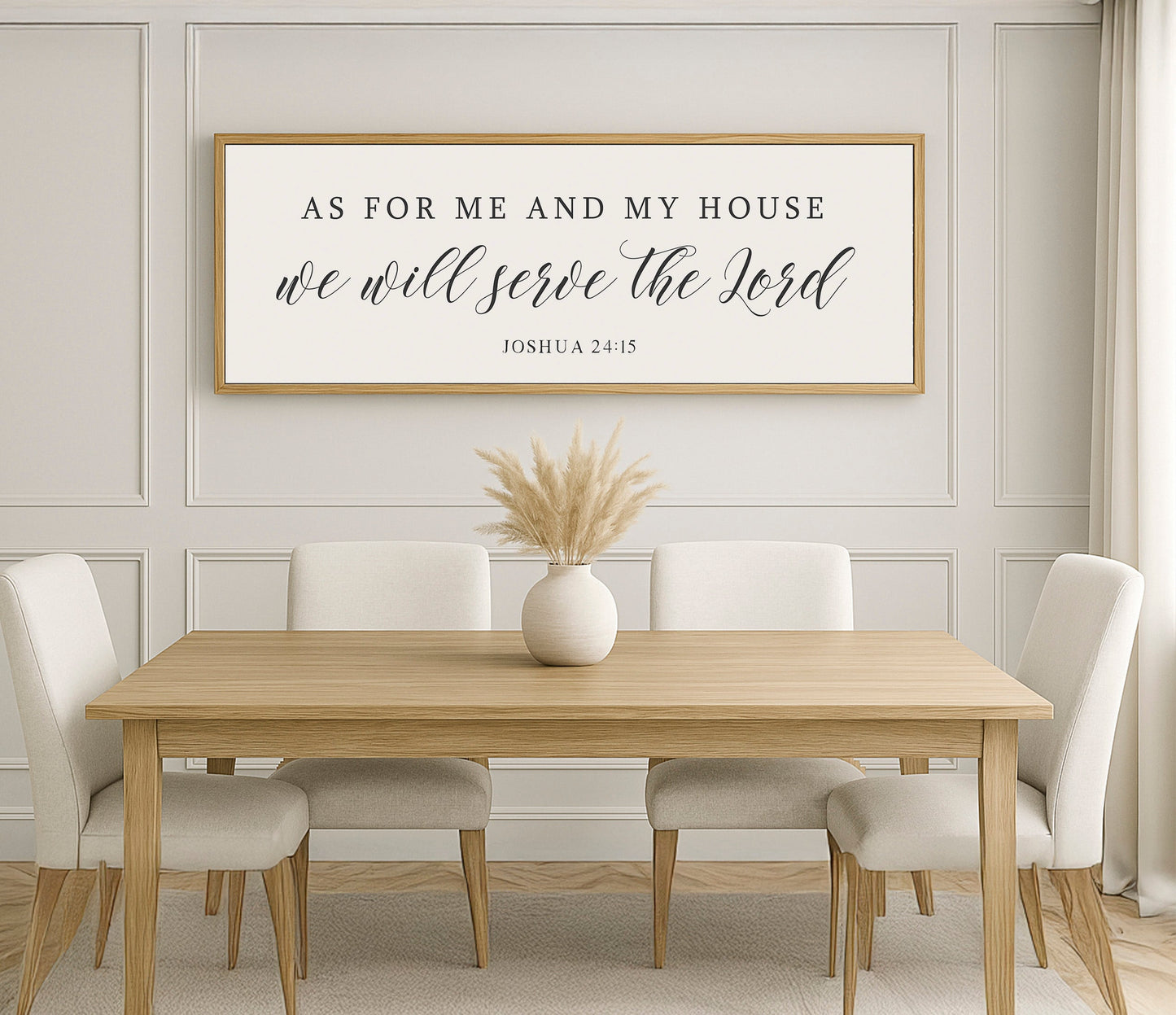 a dining room table with white chairs and a framed sign