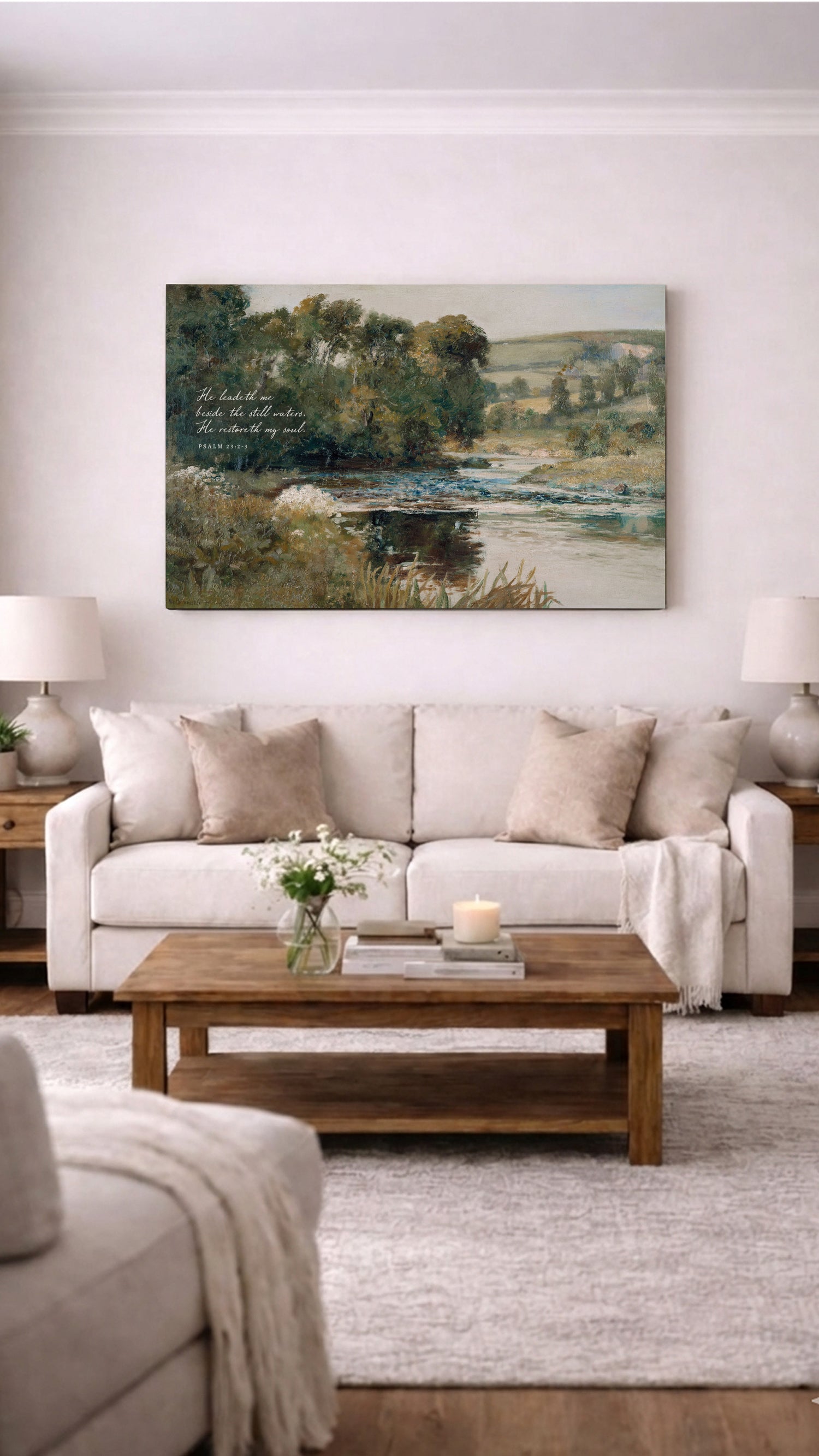 a cozy living room with a large painting of a serene landscape hanging on the wall above a beige sofa and a wooden coffee table. The room is decorated with a vase of flowers, a candle, and a book, creating a warm and inviting atmosphere.