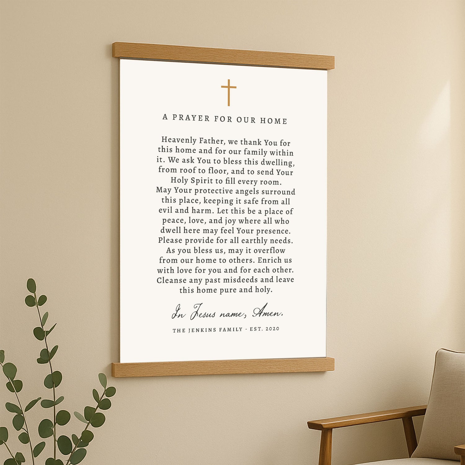 A framed prayer for our home with a green plant in the background.