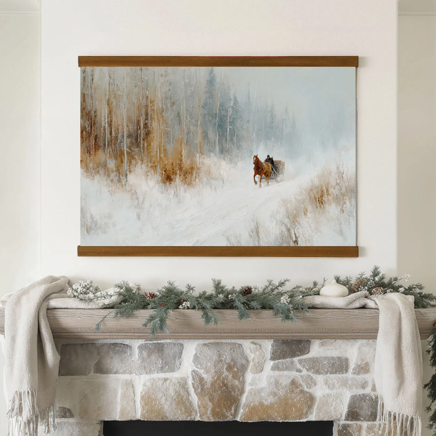 A framed painting of a horse-drawn sleigh in a snowy forest hangs above a stone fireplace mantle decorated with pine branches and pinecones.