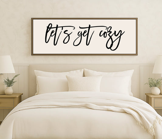 a bed with a white comforter and pillows