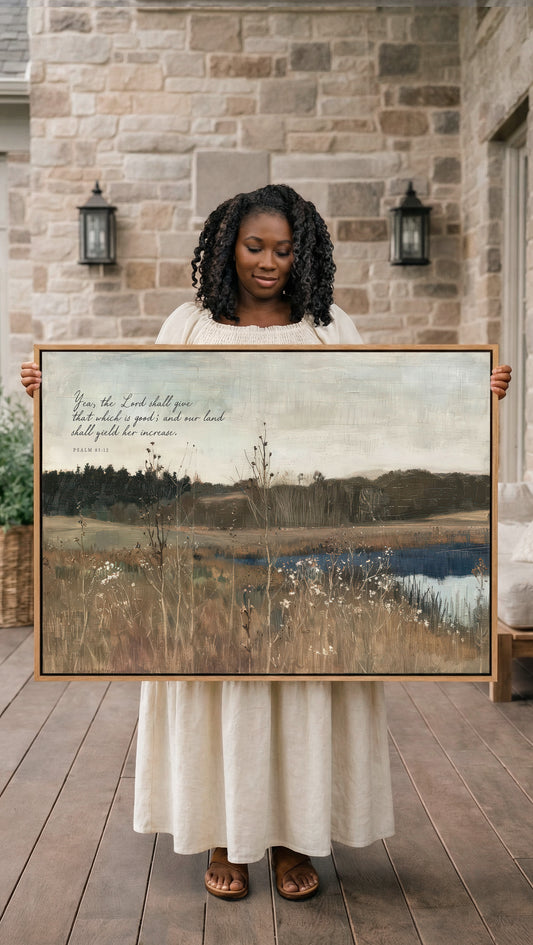 A woman in a white dress holds a large painting of a serene landscape, including a field and a body of water, with a text overlay that reads "From the Lord shall you have enough land, so you shall yield your land to the Lord."