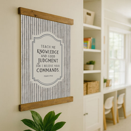 a framed quote on a wall, with a potted plant in the foreground and a bookshelf in the background.