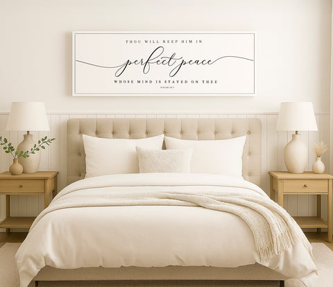 a bed with a white comforter and pillows