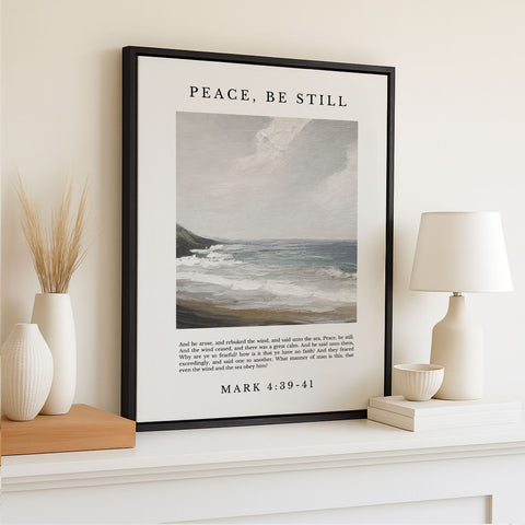 A framed poster of a seascape hangs on a wall, accompanied by a lamp, a vase with dried reeds, and a bowl. The poster displays a verse from the Bible, specifically from the book of Mark, which reads 