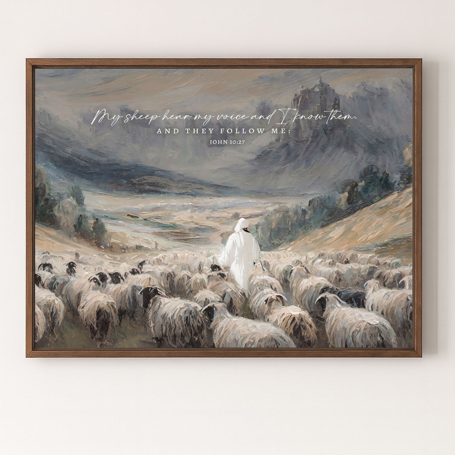 a shepherd tending to his flock of sheep in a mountainous landscape.