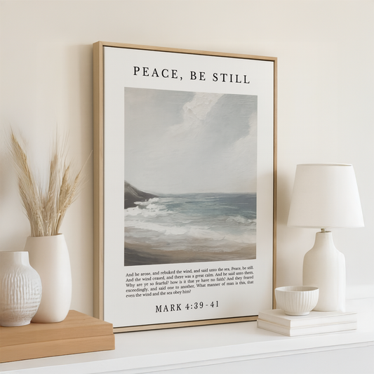 a framed poster of a seascape with a Bible verse from the book of Matthew, accompanied by a lamp and a vase on a shelf.