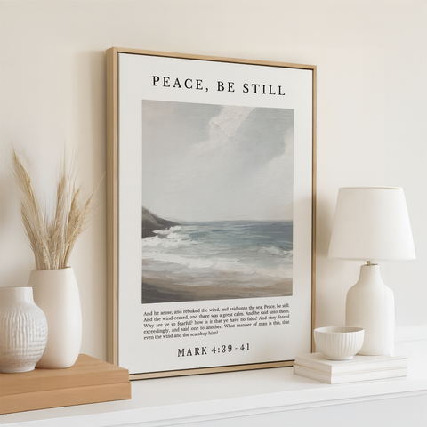 a framed poster of a seascape with a Bible verse from the book of Matthew, accompanied by a lamp and a vase on a shelf.