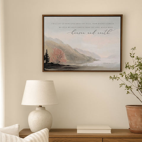 a serene indoor setting with a framed landscape painting hanging on the wall, a lamp on a wooden table, and a potted plant nearby.