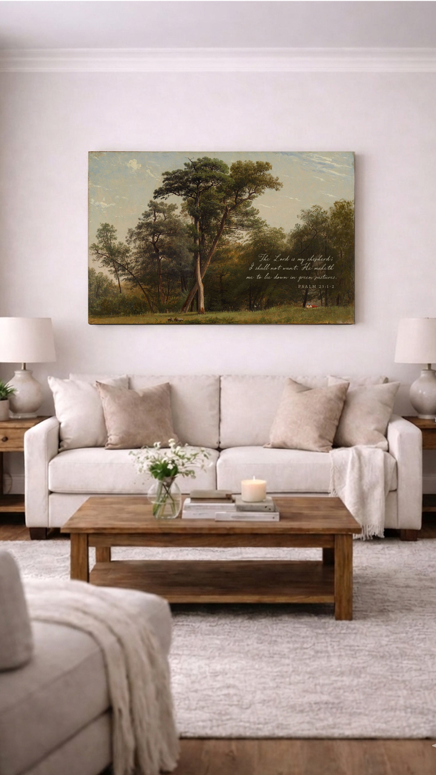 a living room with a large painting of a forest scene hanging on the wall above a beige sofa. The sofa is positioned in front of a wooden coffee table, which has a vase of flowers and a lit candle on it. The room also includes a rug and a side table with a lamp.
