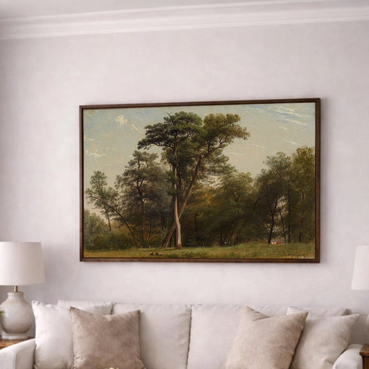 a cozy living room with a large painting of a forest scene hanging on the wall above a beige sofa. The sofa is adorned with two throw pillows and a small vase of flowers. In front of the sofa, there is a wooden coffee table with a lit candle on it. The room has a neutral color scheme with white walls and a gray carpet, creating a warm and inviting atmosphere.
