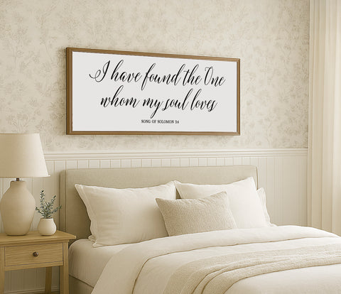 a bedroom with a bed and a picture on the wall