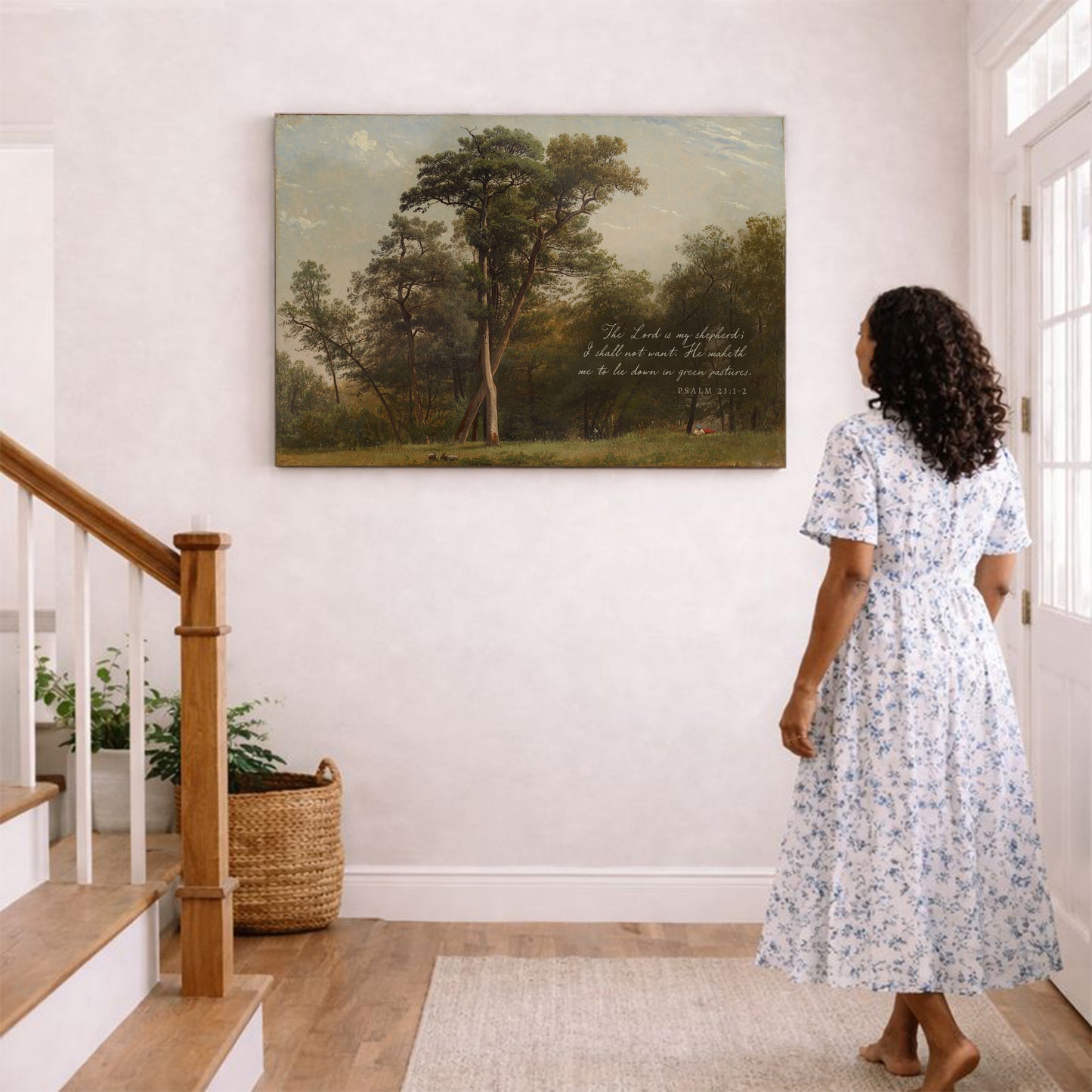 A woman in a white floral dress stands in a hallway, gazing at a painting of a tree on the wall.