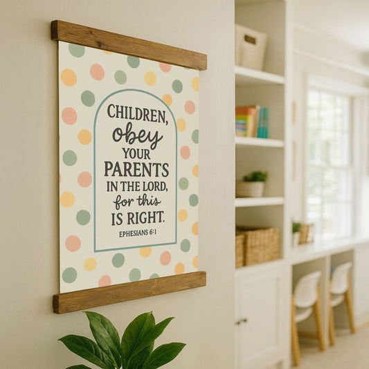 a wall hanging with a Bible verse from Ephesians 6:1, which reads "CHILDREN, OBEY, YOUR PARENTS IN THE LORD, FOR THIS IS RIGHT." The wall hanging is mounted on a wall with a wooden frame, and there is a plant in the foreground.