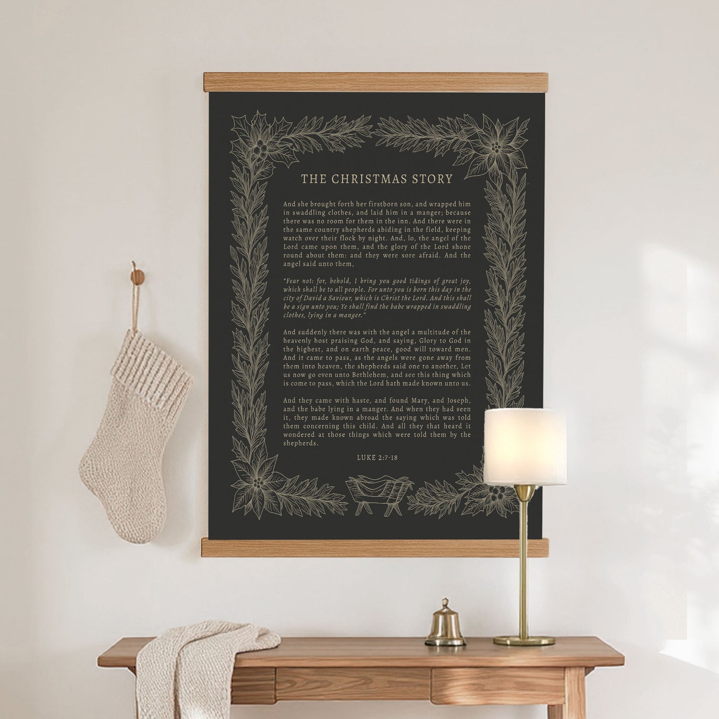 a black poster with a white border hanging on a wall above a wooden table with a lamp and a stocking.