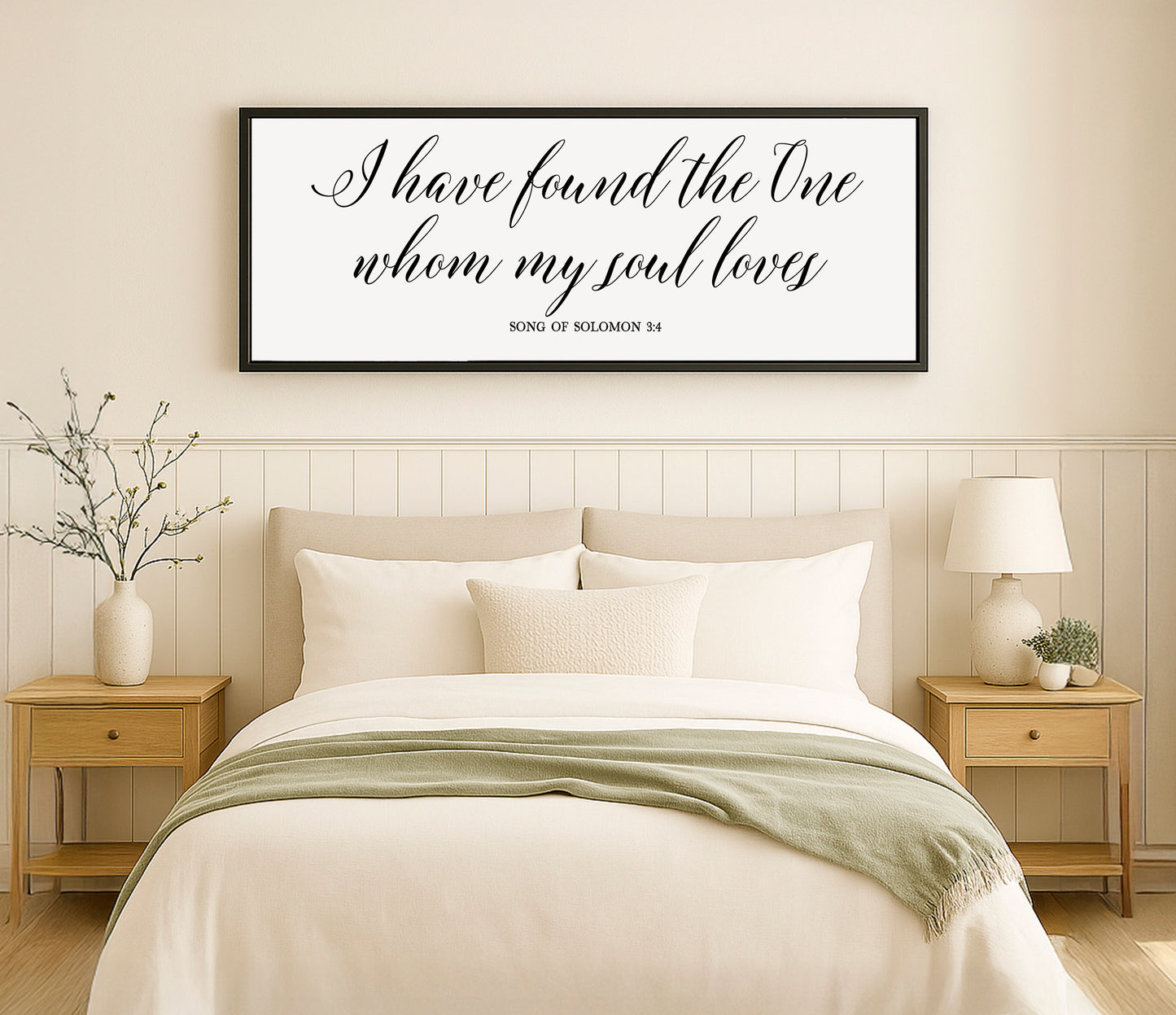 a bedroom with a bed, nightstands and a framed quote