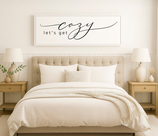 a bed with a white comforter and pillows
