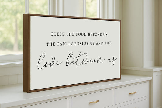 a framed picture of a quote on a window sill