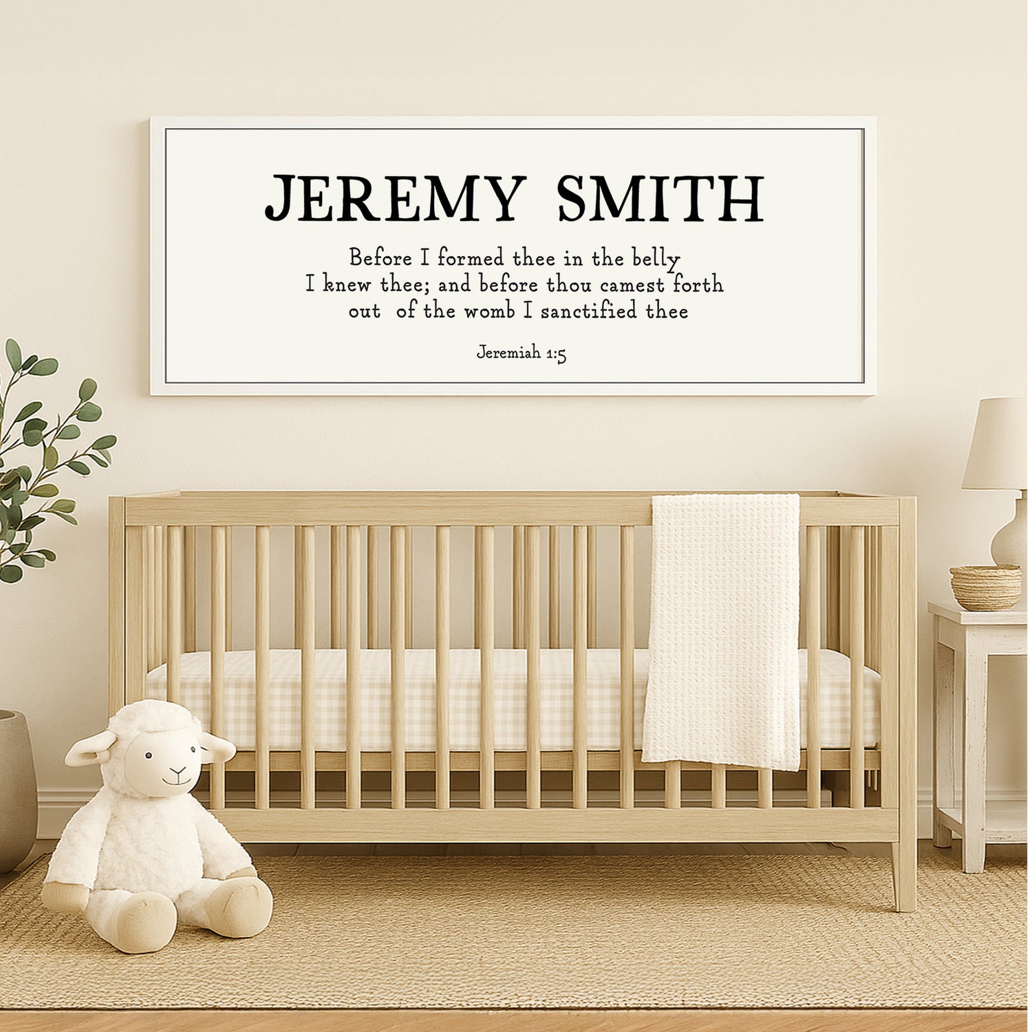 a baby's room with a teddy bear and a framed poster