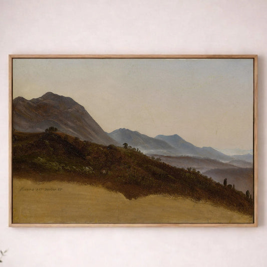 a large landscape painting hanging on a white wall, depicting a serene countryside scene with rolling hills and mountains in the distance.