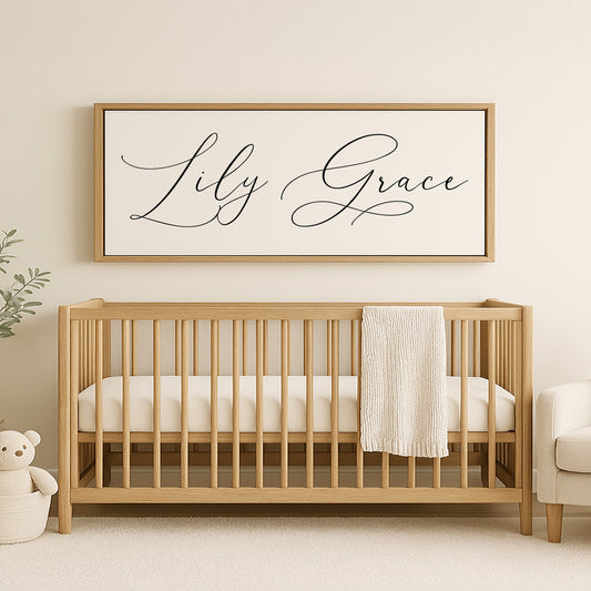 a baby's crib with a teddy bear and a framed sign above it