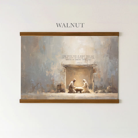 The image is a painting of the Nativity scene, depicting the birth of Jesus Christ, with two figures, likely Mary and Joseph, in the manger. The painting is framed and hung on a wall.