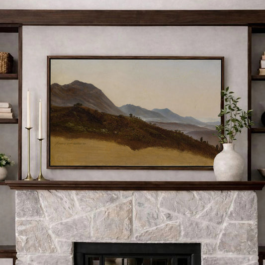 a cozy living room with a stone fireplace, a framed landscape painting above it, and a vase of flowers on a table in front of the fireplace.