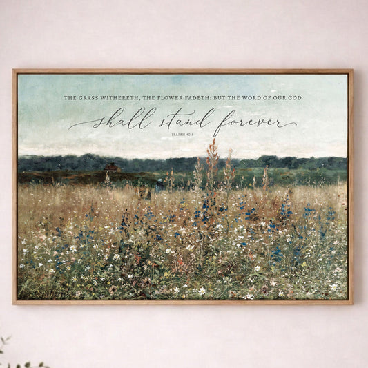The image is a framed print of a pastoral landscape with a field of flowers and a text overlay that reads "The grass witheeth, the flower fadeth; but the word of our God shall stand forever".